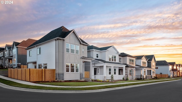 view of front of property with a residential view and fence