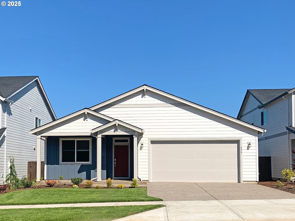836 Misty Ln, Forest Grove, OR 97116 - single story home with concrete driveway, board and batten siding, a garage, and a front lawn