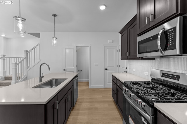 8130 SE Newberry St, Hillsboro, OR 97123 - kitchen with stainless steel appliances, a sink, light wood-type flooring, light countertops, and recessed lighting