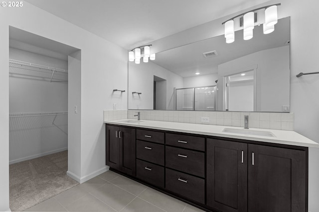 8130 SE Newberry St, Hillsboro, OR 97123 - bathroom featuring a stall shower, double vanity, backsplash, and a spacious closet