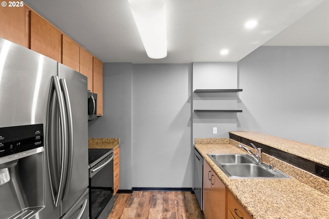 kitchen featuring open shelves, wood finished floors, a sink, stainless steel appliances, and light countertops