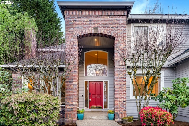 entrance to property featuring brick siding