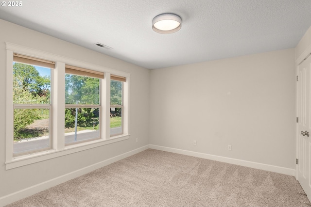 unfurnished room featuring baseboards, a healthy amount of sunlight, visible vents, and carpet floors