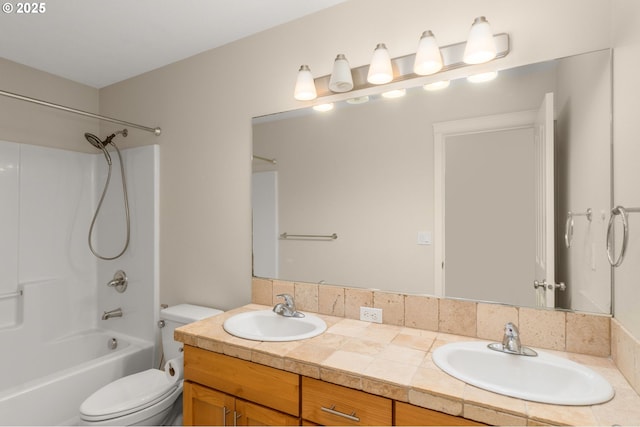 bathroom with double vanity, toilet,  shower combination, and a sink