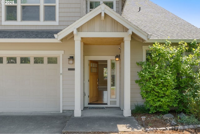 view of exterior entry featuring board and batten siding, roof with shingles, and an attached garage