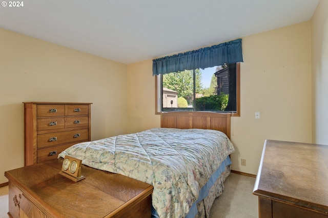 bedroom featuring baseboards and light colored carpet