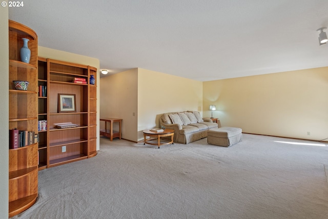 carpeted living room with baseboards