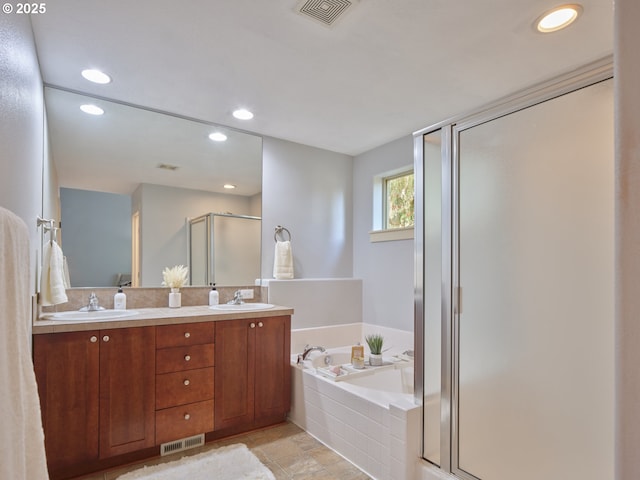 bathroom featuring independent shower and bath and vanity