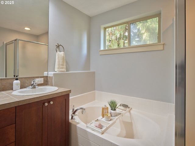 bathroom featuring plus walk in shower and vanity