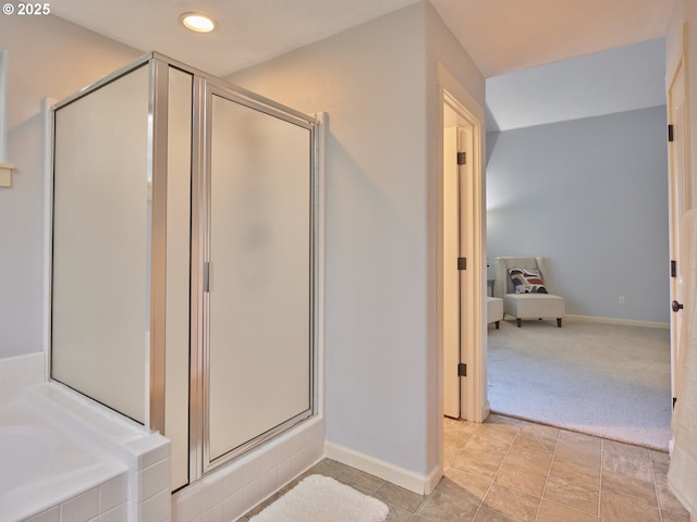 bathroom featuring shower with separate bathtub