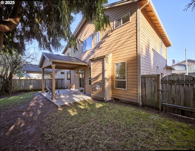 rear view of house with a patio and a yard