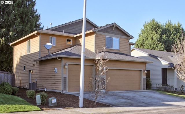 view of front of home with a garage and cooling unit