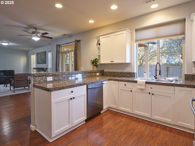 kitchen featuring sink, white cabinets, kitchen peninsula, stainless steel dishwasher, and dark wood-type flooring