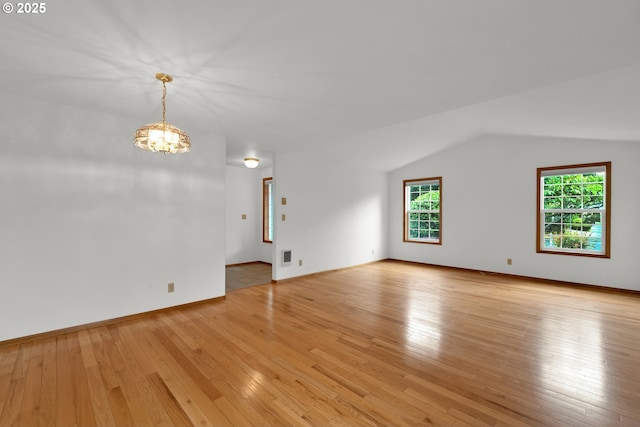 3909 Spruce St, Florence, OR 97439 - unfurnished room with a chandelier, healthy amount of natural light, light wood-type flooring, and vaulted ceiling