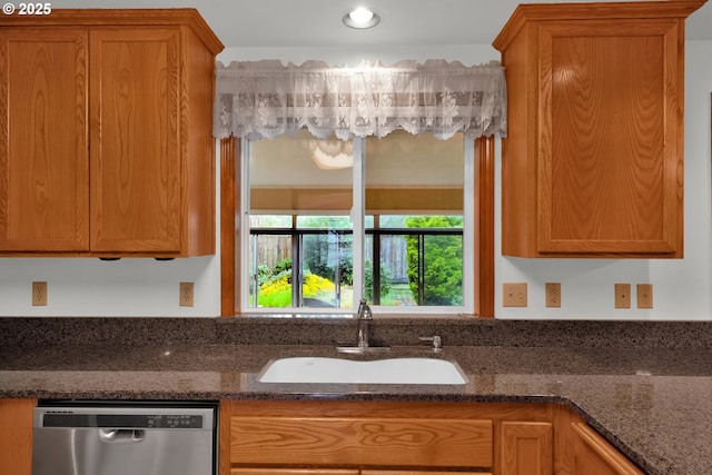 3909 Spruce St, Florence, OR 97439 - kitchen featuring stainless steel dishwasher, a sink, brown cabinets, and dark stone countertops