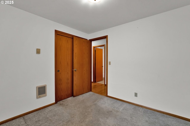 3909 Spruce St, Florence, OR 97439 - unfurnished bedroom featuring carpet floors, a closet, baseboards, and heating unit