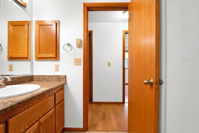3909 Spruce St, Florence, OR 97439 - bathroom featuring wood finished floors, vanity, and baseboards