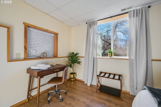 office area with wood-type flooring and a paneled ceiling