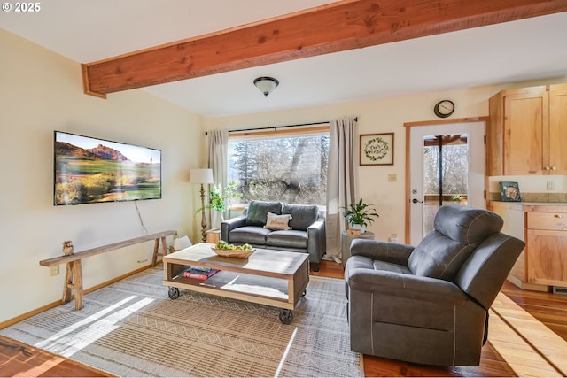 living room featuring beamed ceiling and hardwood / wood-style flooring