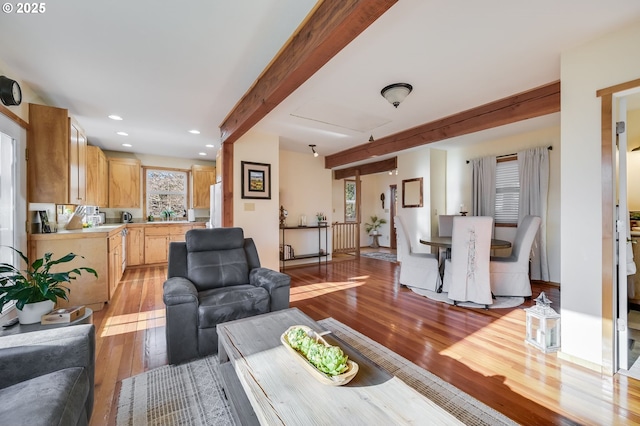 living room featuring light hardwood / wood-style floors and beamed ceiling