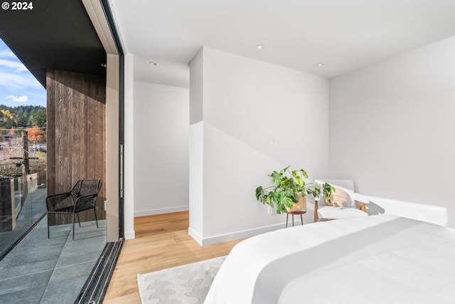 2797 NW Thurman St, Portland, OR 97210 - bedroom with wood finished floors, floor to ceiling windows, recessed lighting, baseboards, and access to exterior