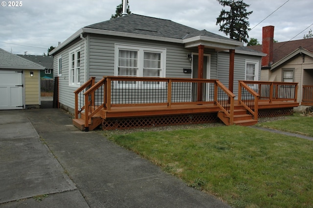 124 S 20th St, Saint Helens, OR 97051 - back of property featuring roof with shingles, a yard, a wooden deck, and a garage