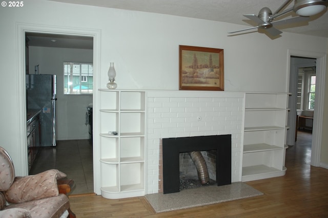 124 S 20th St, Saint Helens, OR 97051 - living room featuring a ceiling fan, wood finished floors, and a fireplace