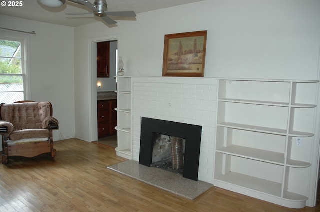 124 S 20th St, Saint Helens, OR 97051 - living room with wood finished floors, ceiling fan, and a brick fireplace