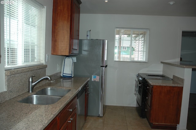 124 S 20th St, Saint Helens, OR 97051 - kitchen with black electric range oven, healthy amount of natural light, light tile patterned flooring, and light stone counters