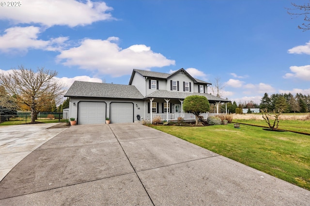 view of front of house with a front yard, fence, driveway, covered porch, and a garage