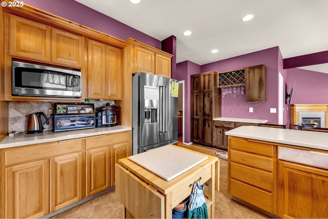 kitchen featuring recessed lighting, tasteful backsplash, appliances with stainless steel finishes, and light countertops