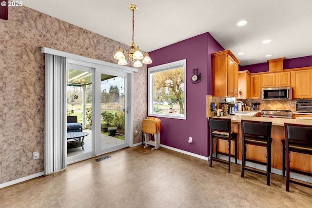 kitchen with visible vents, a sink, tasteful backsplash, appliances with stainless steel finishes, and light countertops