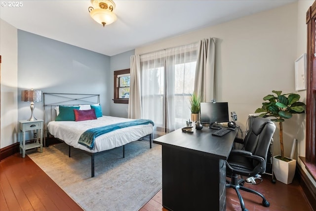 bedroom featuring wood-type flooring and baseboards