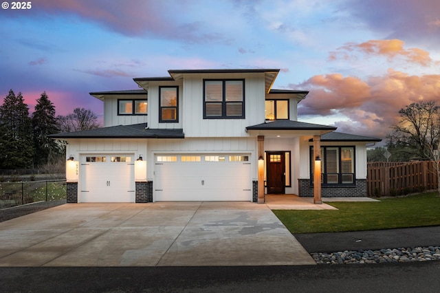 view of front facade with a garage and a yard