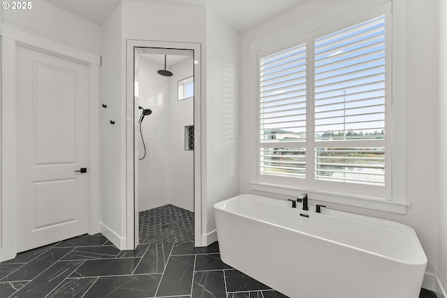 bathroom featuring separate shower and tub