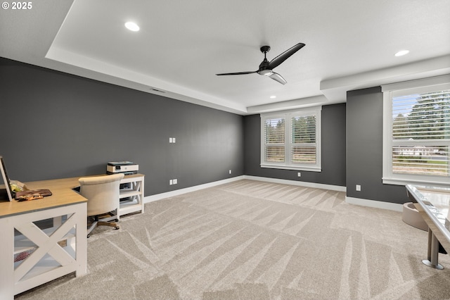 unfurnished office featuring ceiling fan and light colored carpet