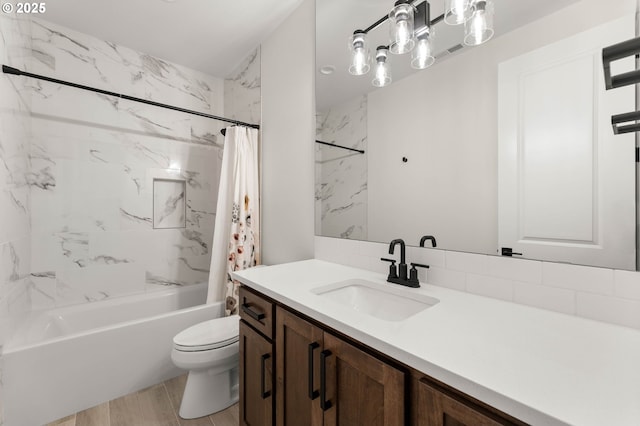 full bathroom with vanity, shower / tub combo, and toilet