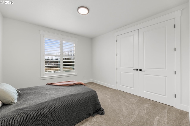 bedroom with light carpet and a closet