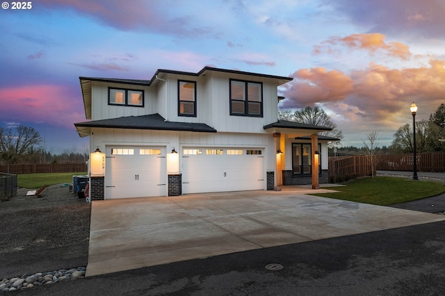 view of front of property with a garage and central AC