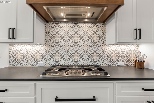 kitchen featuring custom range hood, backsplash, white cabinets, and stainless steel gas cooktop