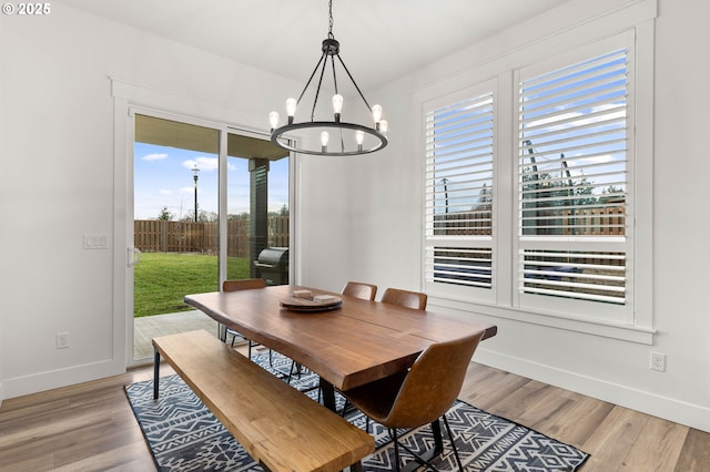 dining space featuring a notable chandelier and light hardwood / wood-style floors