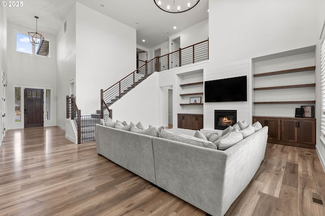 living room with wood-type flooring and a chandelier