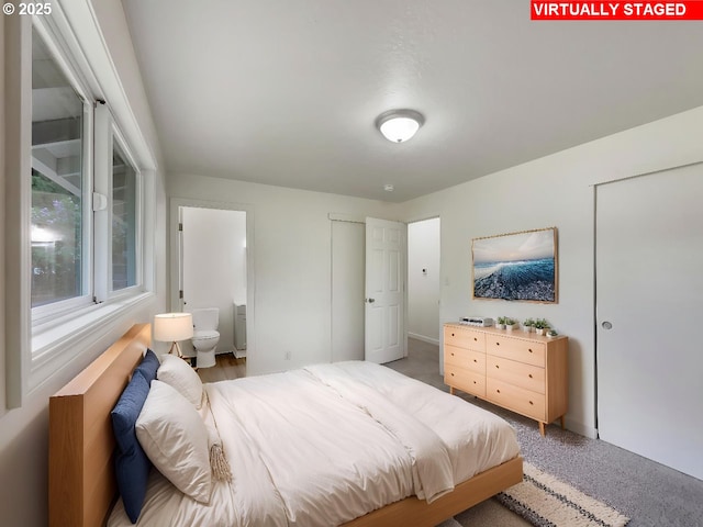 bedroom featuring carpet flooring and ensuite bath