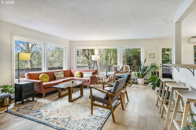 sunroom with a wall mounted air conditioner