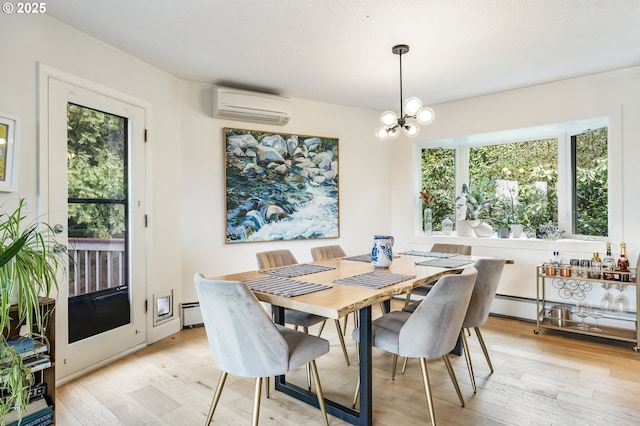 dining space featuring a chandelier, an AC wall unit, a baseboard heating unit, and light wood finished floors