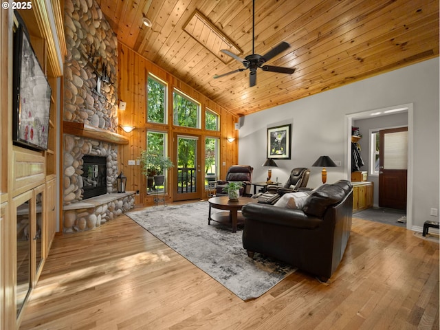 25210 E Arrah Wanna Blvd, Welches, OR 97067 - living area featuring a fireplace, wooden ceiling, vaulted ceiling, light wood-style floors, and a ceiling fan