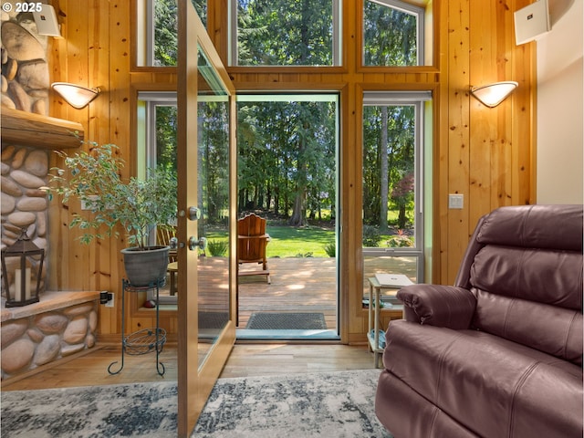 25210 E Arrah Wanna Blvd, Welches, OR 97067 - doorway to outside with healthy amount of natural light, wood walls, wood finished floors, and a towering ceiling
