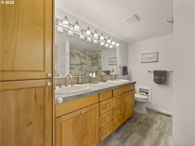 25210 E Arrah Wanna Blvd, Welches, OR 97067 - bathroom featuring walk in shower, toilet, a textured ceiling, and double vanity