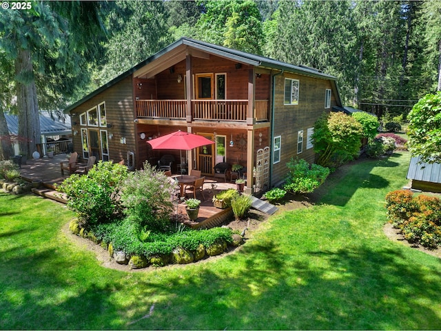 25210 E Arrah Wanna Blvd, Welches, OR 97067 - rear view of house with a balcony, a yard, a wooden deck, and outdoor dining space