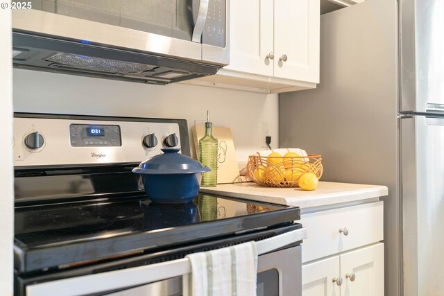 12620 NW Barnes Rd, Portland, OR 97229 - kitchen featuring appliances with stainless steel finishes and white cabinets